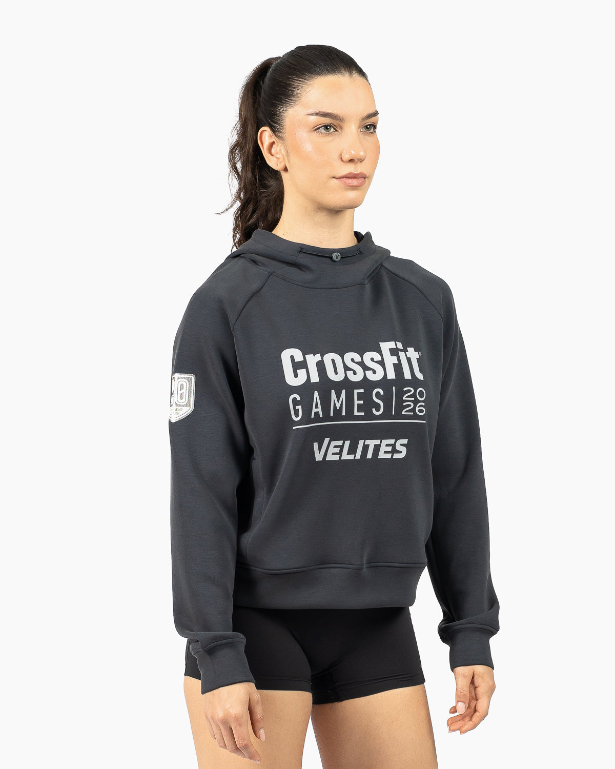 Model wearing the black women's HOLO 20th Anniversary CrossFit Games crop hoodie three-quarter view