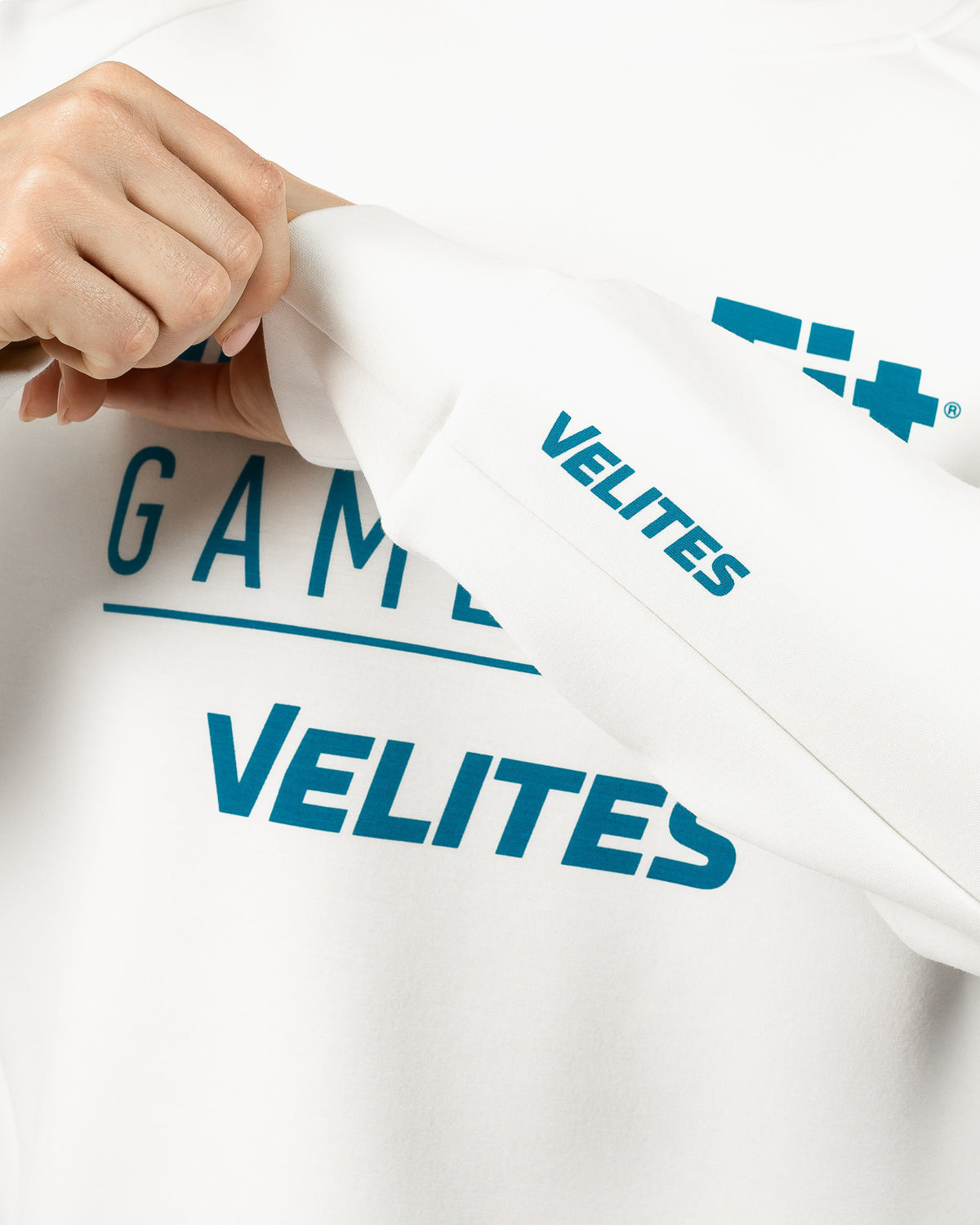 Close-up detail of the printed text graphic on the official Velites capsule collection crop sweatshirt